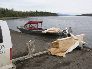 Lumber is transferred onto the boat.