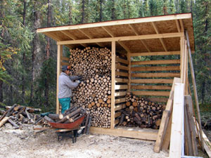 The finished wood shed is filled with firewood from the clear-cut.